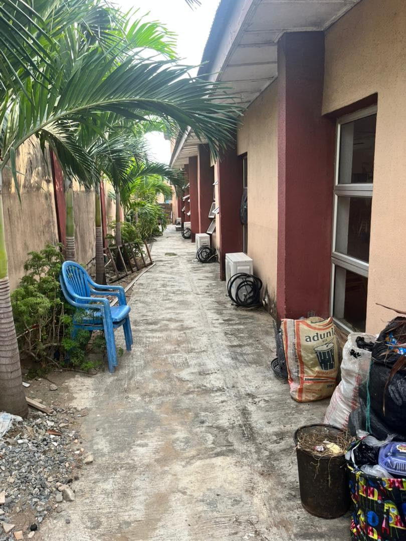 A cluttered side walkway alongside the current church building.